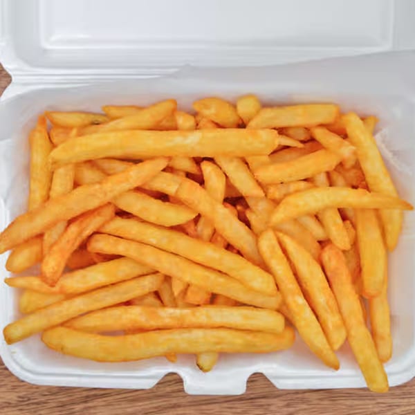 Golden-brown french fries in a white takeout container from Pizza Connect & Grill.